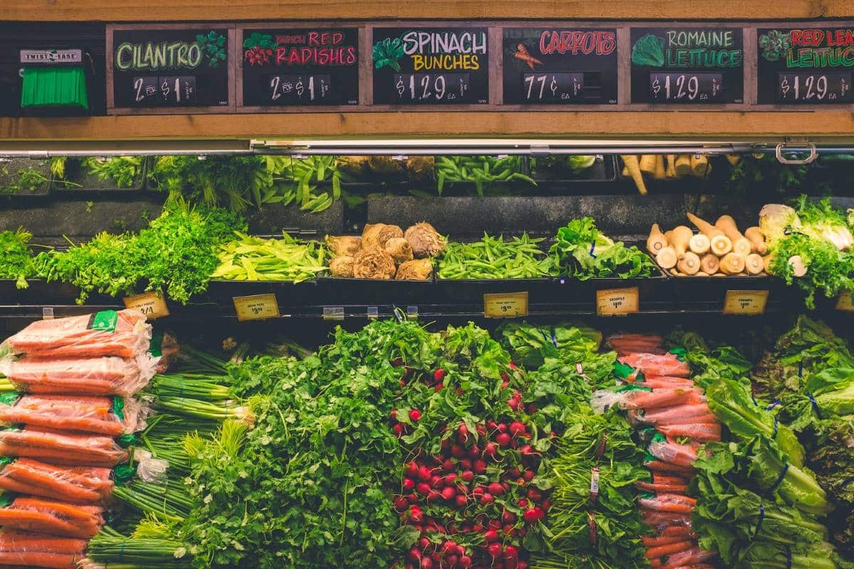 Grocery store shelves full of fresh vegetables