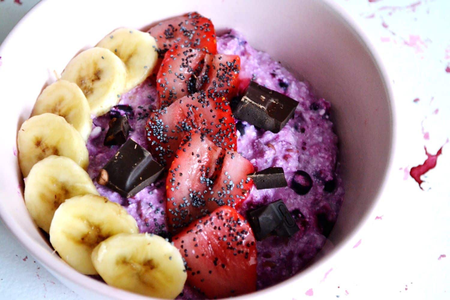 Smoothie bowl topped with banana, strawberry, dark chocolate, and hemp seeds