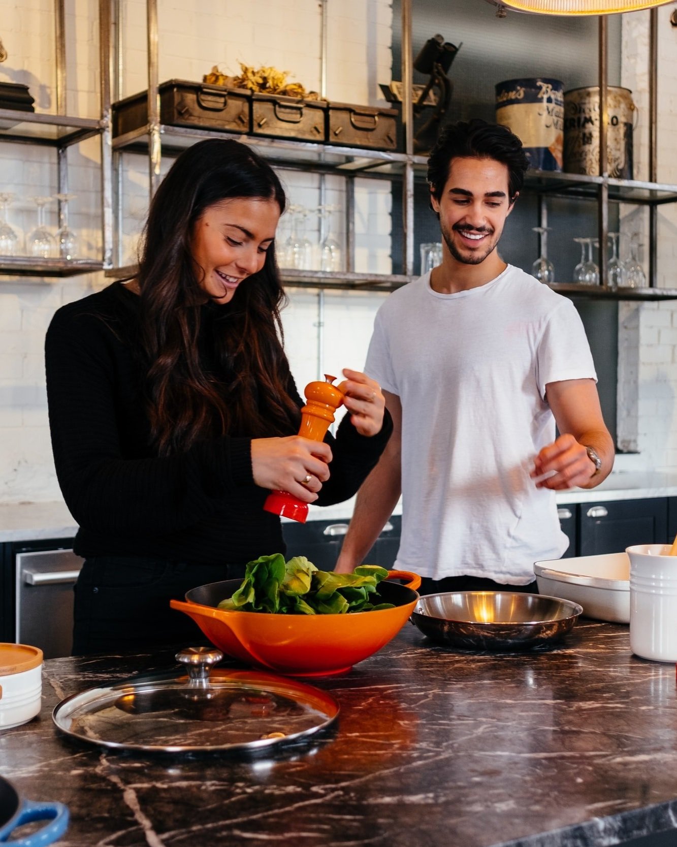 Man and woman making a salad together in their kitchen